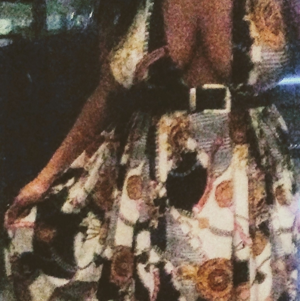 A floor length flowing sleeveless print dress